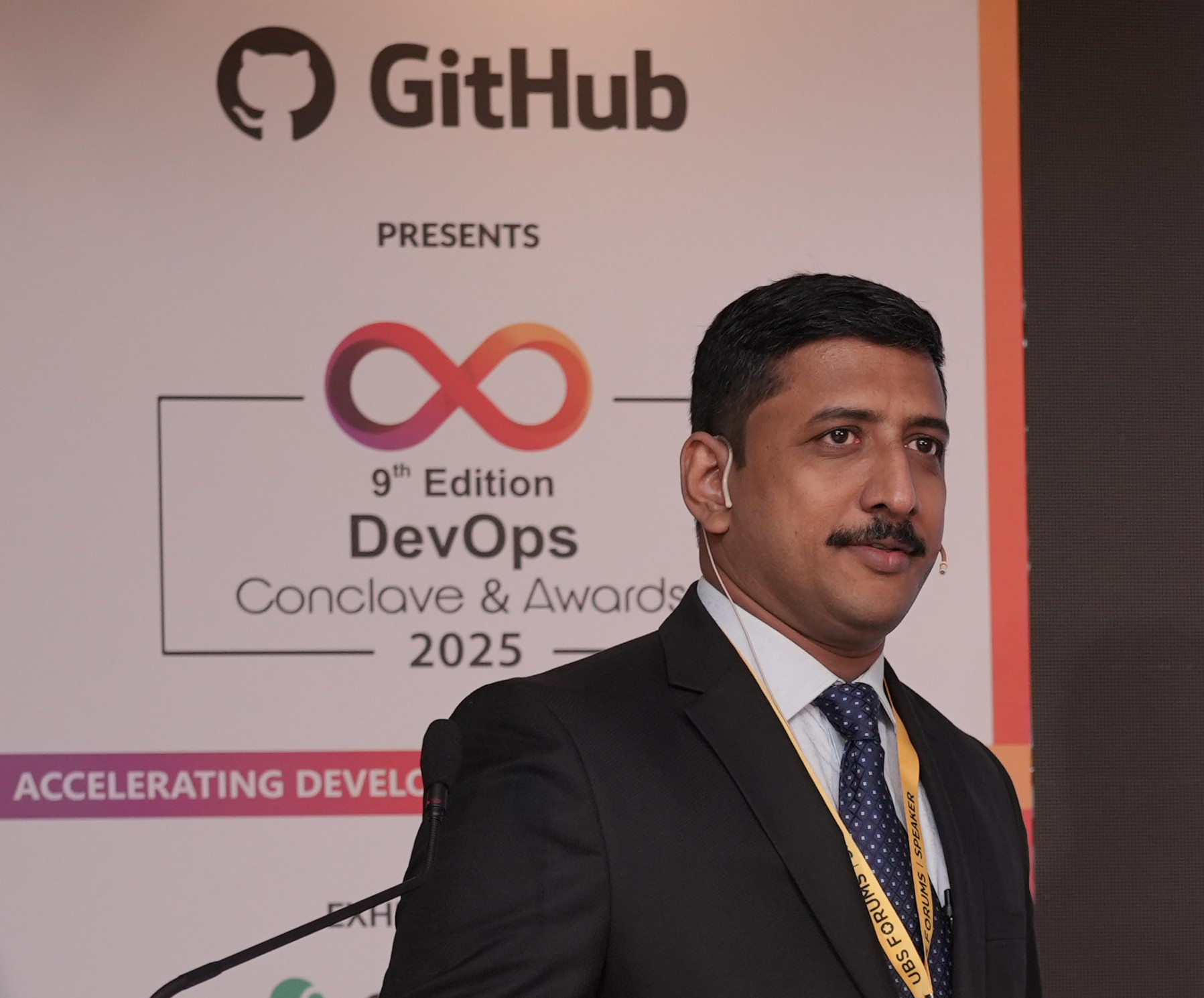 Varghese Chacko speaking at the DevOps Conclave & Awards 2025, presented by GitHub